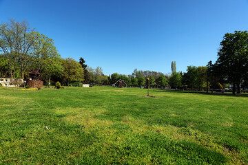 A clearing in the park with a playhouse © Alex