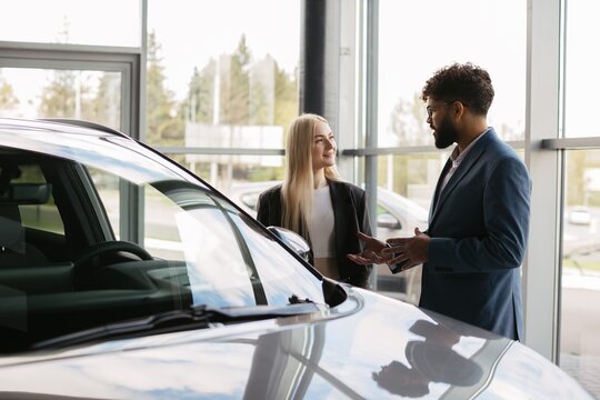 Customer discussing new car purchase with salesman