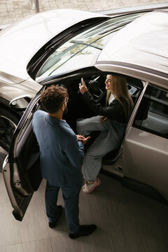 Woman test driving new car at dealership