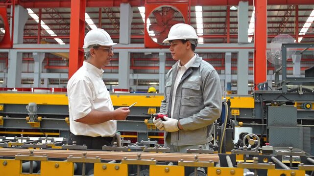 Factory meeting supervisors collaborate on production strategies industrial plant professional discussion bright environment close-up view