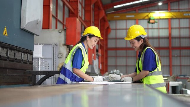 Collaboration in manufacturing industrial facility teamwork scene bright environment close-up perspective safety in action