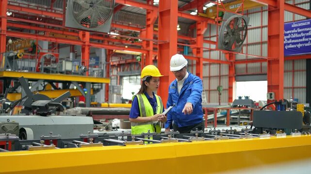 Collaboration in a manufacturing facility engineers analyzing plans industrial environment professional viewpoint