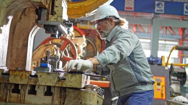 Machinery operation by skilled technician industrial workshop photography manufacturing environment close-up view precision work