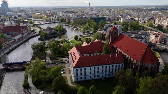 Aerial view drone flying over Wroclaw touristic city center, churches, islands and Odra river at sunny summer day