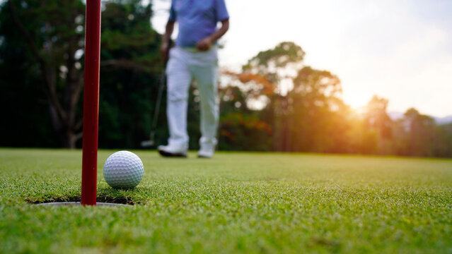 Golfers are putting golf in the evening golf course golf backglound.