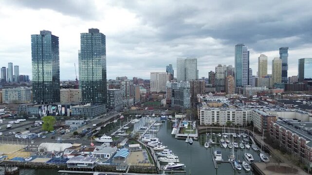 Skyline marina frontage captures Liberty Landing Marina, Morris Canal Basin clustered docks framed by high rise towers Audrey Zapp Dr. Glass reflections, hull textures, diffused cloud light, NJ