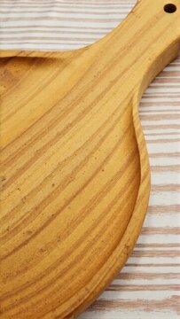 A handcrafted wooden violin bow, showcasing the grain and craftsmanship of an artisan luthier. This custom piece is both functional and a decorative representation of violin strings.
