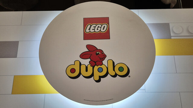 Red and yellow LEGO and DUPLO logos on a white circular surface featuring a red rabbit mascot over a tiled background. Picture taken on April 27, 2026 in Bucharest, Romania.