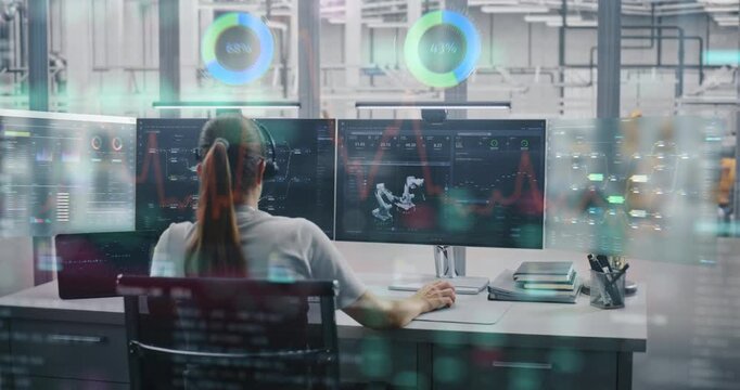 Young Female Engineer in Headset Sits at Desk, Monitoring Automated Robotic Arms Through Multiple Screens With Glowing VFX Charts, Holograms, and Production Data Analytics. Concept of Industry 4.0.