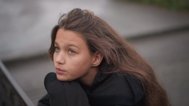 Hopeful teen looking skyward after rain, puddlelined walkway and wet railing, expressive profile with soft pink hair streak, upward gaze suggesting resilience and future focus, cinematic framing