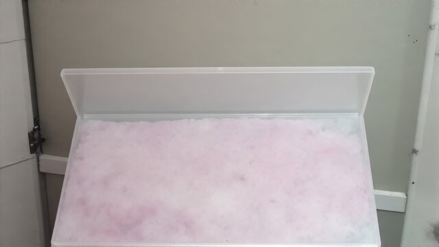 A sheet of pink polystyrene foam board with a smooth surface.