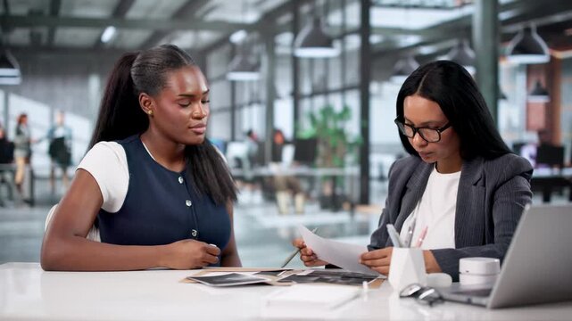 Lawyer Going Though Evidence And Contracts At Meeting With Client
