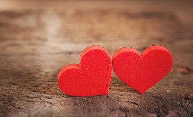 Fototapeta premium Two red hearts on wooden background, valentine's day concept