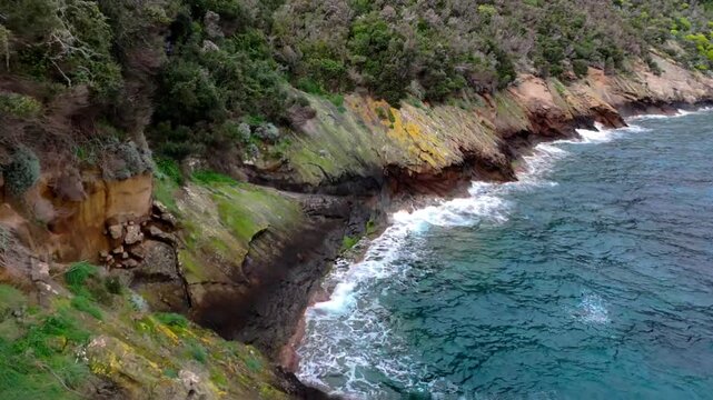 Drone aerial footage showing Vivara Island located next to the colorful island of Procida.