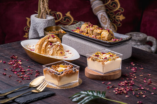 oum ali dessert, baklava, raisin pannacotta and almond pannacotta arranged neatly