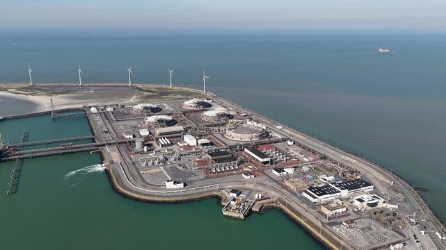 Aerial view of lng terminal and wind turbines in a seaport