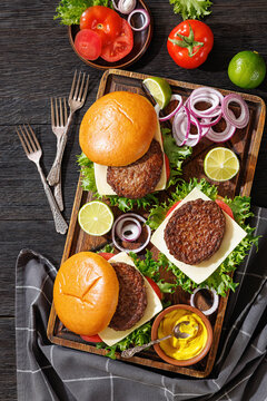 beef cheeseburgers with brioche buns on a tray