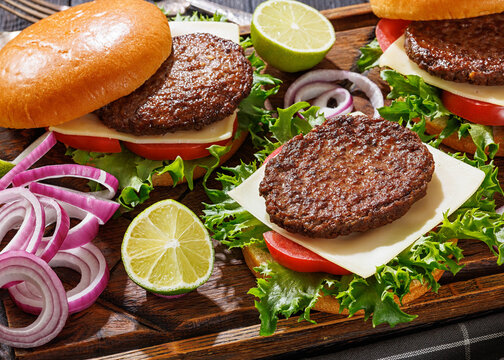 beef cheeseburgers with brioche buns on a tray