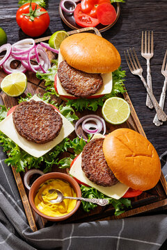 beef cheeseburgers with brioche buns on a tray