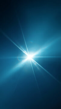 A bright light shining with rays on a blue background with a glowing effect and lens flare