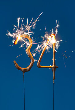 34 years celebration festive background made with Bengal fires in the form of number Thirty four. Vertical photography.
