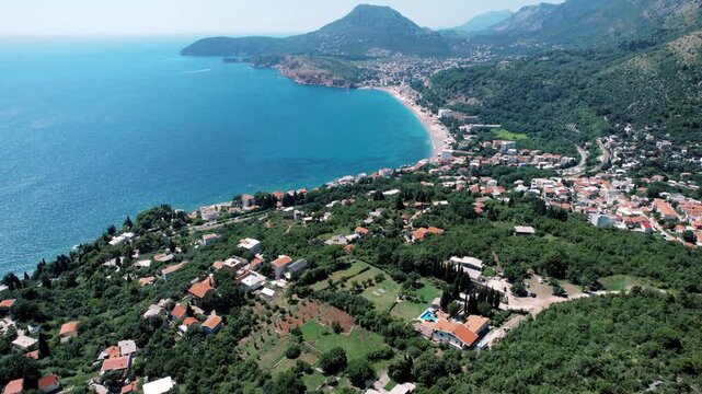 Serene seaside hamlet. Picturesque hillside settlement overlooking azure waters
