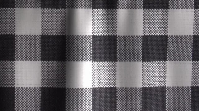 Seamless black and white checkered pattern featuring a geometric square textile design with a vintage chessboard texture perfect for retro fabric material or a seamless vector backdrop