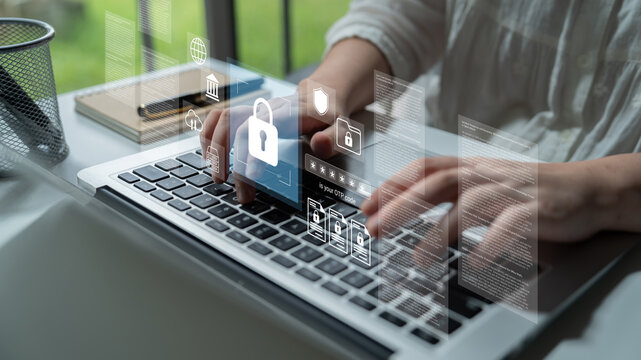 A person actively types on a laptop keyboard while digital security icons overlay a modern workspace, symbolizing online privacy and data protection in technology. Gantry