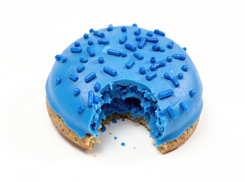 A close-up view of a blue frosted donut with a bite taken out, great for food or dessert imagery