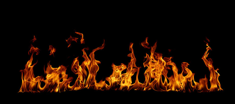 Realistic fire flames isolated on black background, burning orange blaze with dynamic heat motion, ideal for overlay, visual effects, cinematic scenes, and dramatic design compositions.