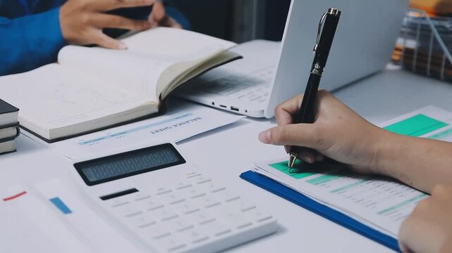 Auditor and accountant team working in office, analyze financial data and accounting record with calculator. Accounting company provide finance and taxation planning for profitable cash flow