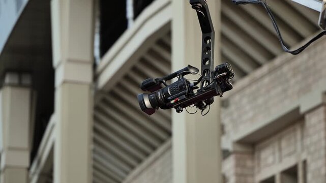 Video camera on a jib arm capturing live action in a large stadium