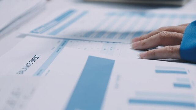 Auditor and accountant team working in office, analyze financial data and accounting record with calculator. Accounting company provide finance and taxation planning for profitable cash flow