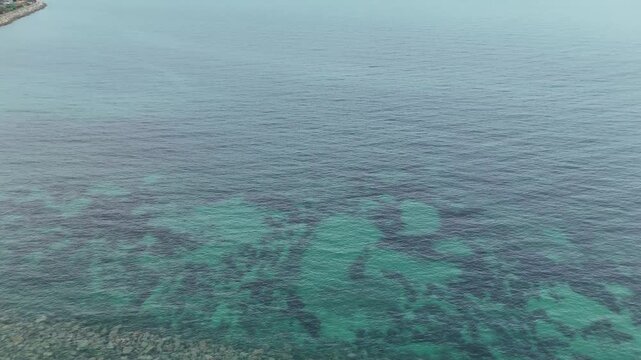 Aerial Seawall and Calm Blue Ocean Coastline