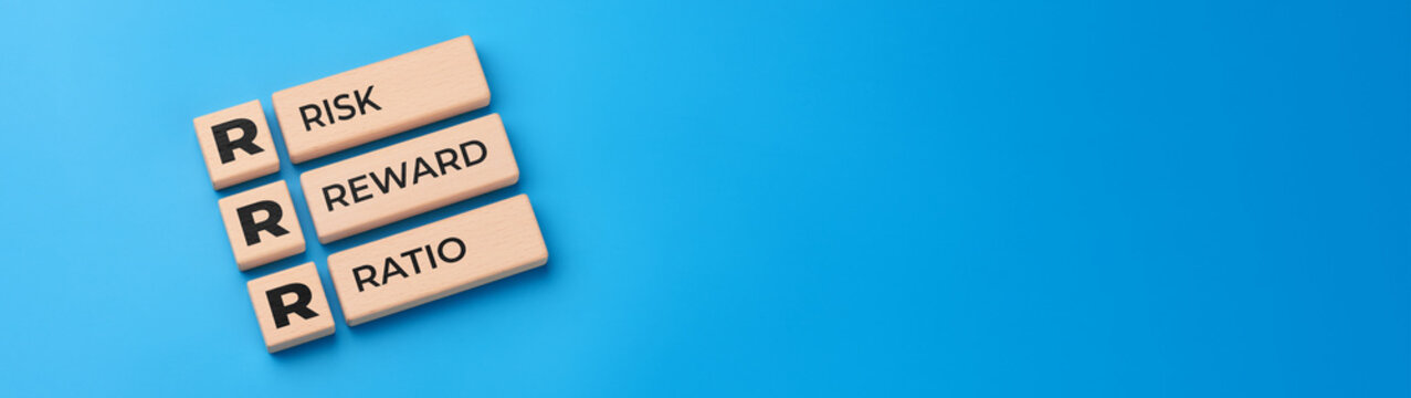 Risk reward ratio concept with wooden blocks and RRR abbreviation