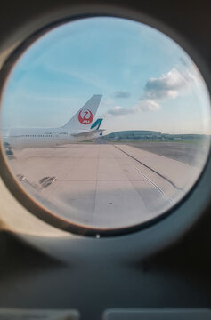 Bangkok, Thailand - April 10, 2017 - Tails of Japan Airlines and Cathay Pacific planes in the parking lot of Suvarnabhumi Airport