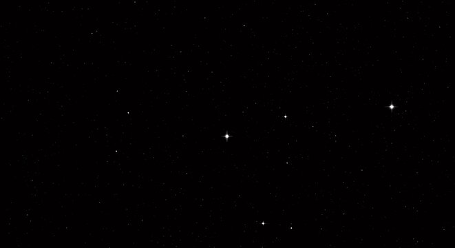 A clear night sky filled with countless stars, some appearing brighter than others, against a deep black background.