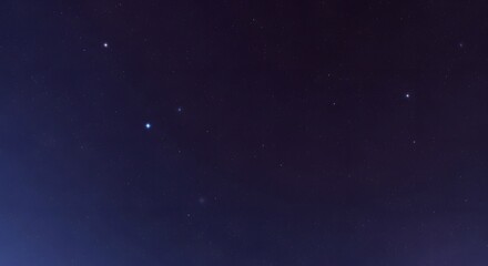 Obraz premium A clear night sky filled with countless twinkling stars and a faint nebula.
