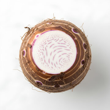 Taro root cut open revealing the starchy interior and concentric rings.