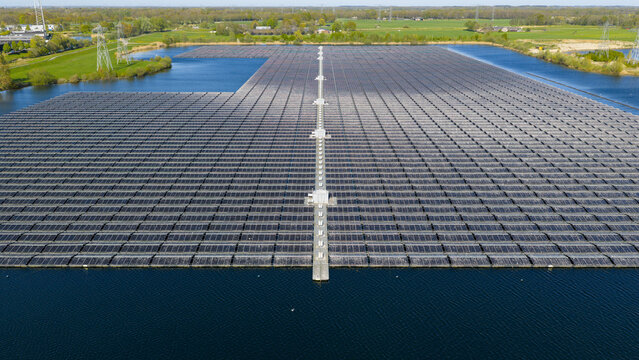 Aerial view of Sekdoornse Plas floating solar farm with thousands of photovoltaic panels on the water surface under a clear sky Zwolle, Overijssel, Netherlands.