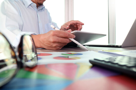 Business Professional Working with Tablet and Reports
