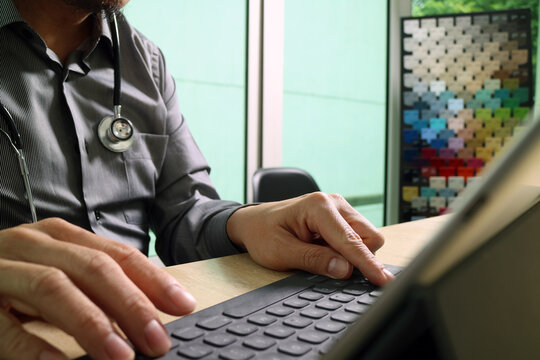 Doctor Working on Tablet in Clinic Office