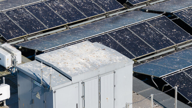 Aerial view of Sekdoornse Plas floating solar farm with solar panels covered in bird droppings and an electrical transformer box Zwolle, Overijssel, Netherlands.