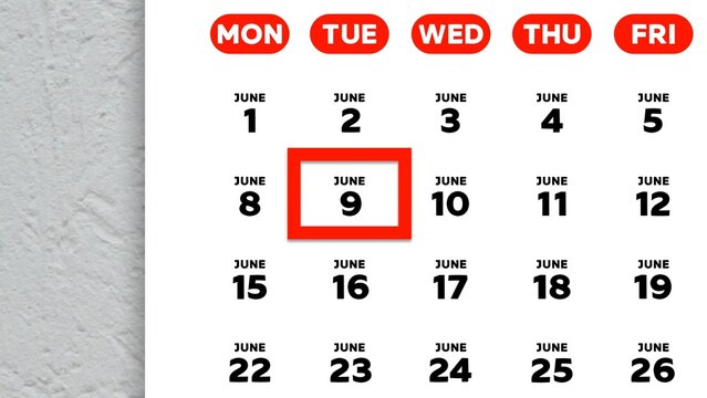 Close-up of the date June 9th marked with a red cursor on the wall calendar 2026