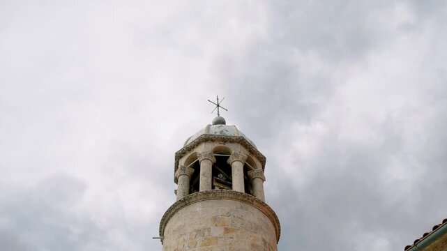 Old stone bell tower with brooding sky and intricate masonry details
