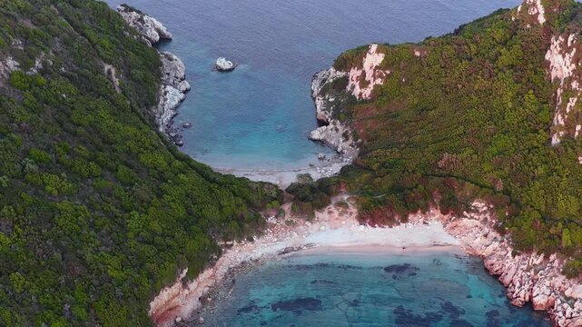 Aerial view of Porto Timoni double beach with clear turquoise water and lush green hills in Afionas, Corfu, Greece. Beautiful summer travel destination