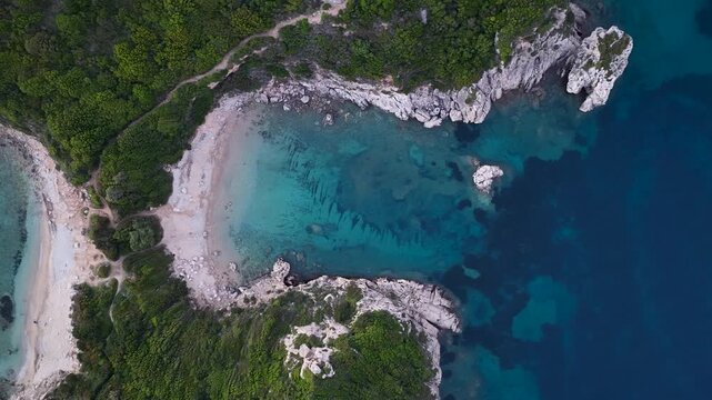 Aerial top-down view of Porto Timoni double beach and crystal clear water in Afionas, Corfu, Greece