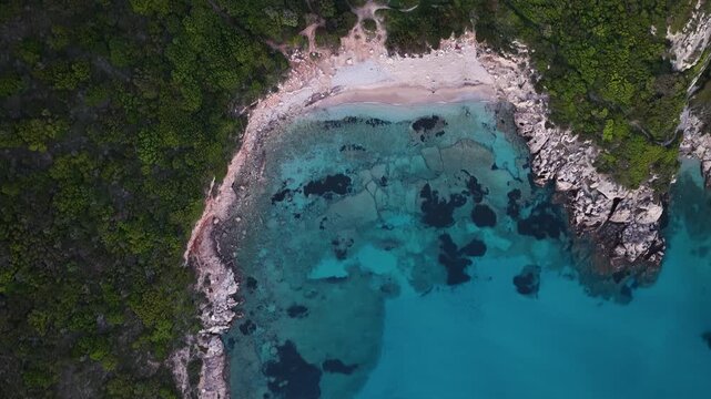 Top-down drone view of the rocky coastline and turquoise waters at Porto Timoni beach, Corfu, Greece