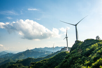 Wind turbines on green mountain ridges in rural China, representing renewable energy development...