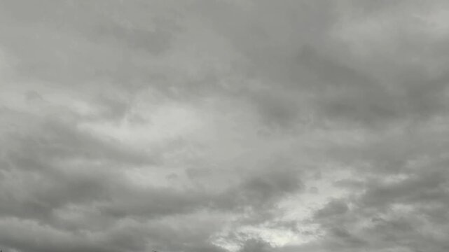 Time-lapse of dark ominous clouds rolling across a gloomy sky.